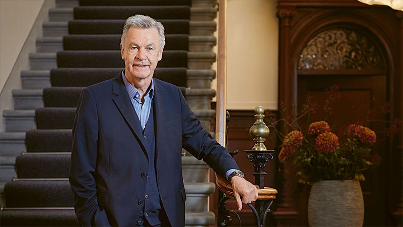 Ottmar Hitzfeld standing on a staircase.